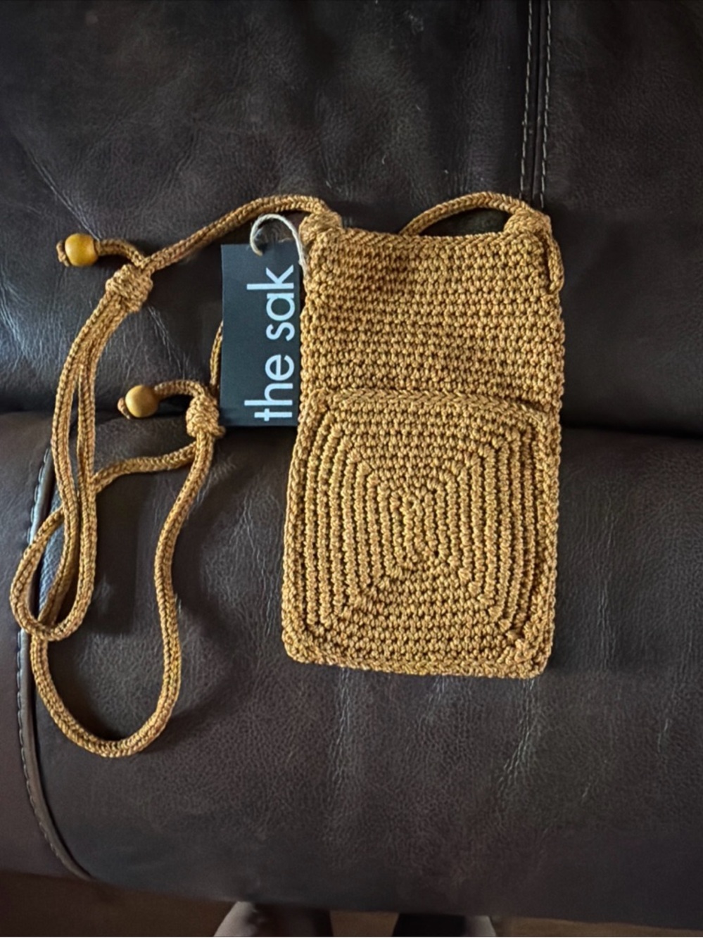 The Sak tan woven crossbody pouch